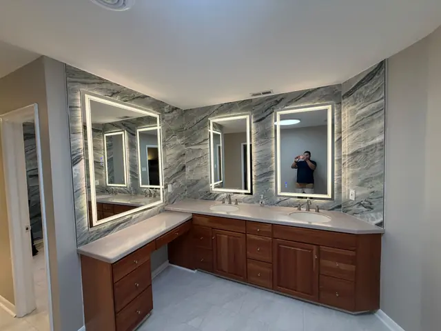 Master bathroom with double vanity and backlit mirrors