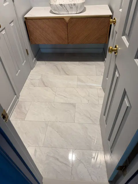 Powder room with porcelain tile floor and wood vanity