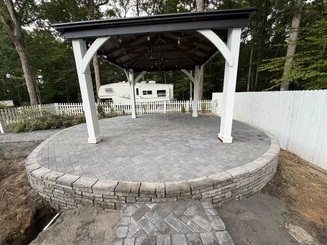 Paver patio with gazebo and stone seat wall