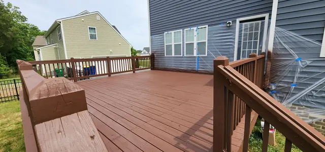 Stained wood deck with built-in bench and railings